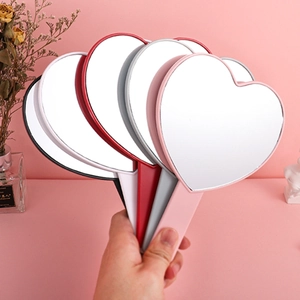 Heart-shaped handheld makeup mirrors in multiple colors with ergonomic plastic handles