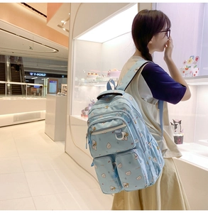 Light blue school backpack with cute white bear patterns and multiple pockets