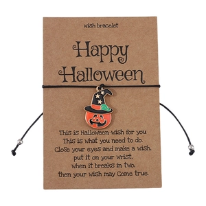 Detail of Halloween wish bracelet featuring a pumpkin charm on a brown card