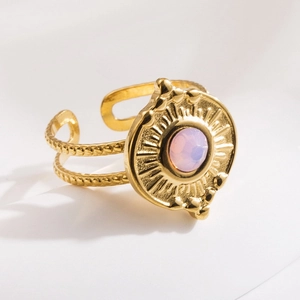 18K gold plated titanium ring featuring a round pink gemstone with sunburst design