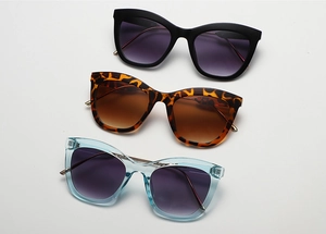 Three pairs of cat-eye sunglasses in matte black, leopard print, and light blue frames