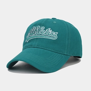 Detailed close-up of vintage Athletics embroidery on a teal cotton baseball cap