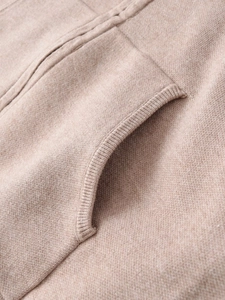 Macro shot of high-quality knit fabric texture and pocket stitching on oatmeal lounge set