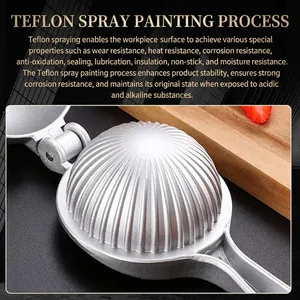 Manual zinc alloy lemon squeezer with non-stick coating on a wooden cutting board