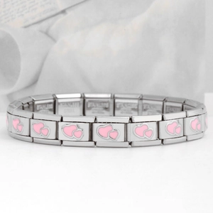 Macro detail of stainless steel modular bracelet featuring pink enamel heart patterns