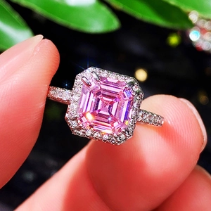 Radiant cut pink halo engagement ring with pavé diamond band in polished silver