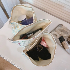 Detailed set of three floral cotton cosmetic bags with durable zippers and cream linings