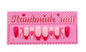 Detail of pink and dark rose handmade press-on nails with floral art and French tip designs