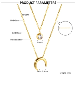 Detail of gold plated stainless steel double necklace with moon and round zircon pendants