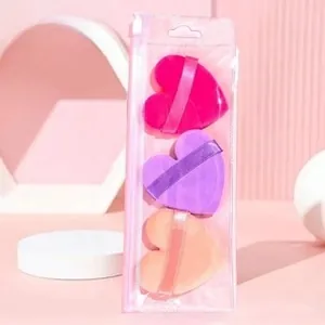 Three heart-shaped makeup sponges in pink, purple, and beige within a zipper pouch