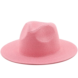 Detailed close-up of pink woven paper straw fedora hat featuring spiral weaving texture