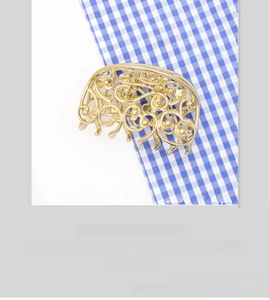 Detailed view of golden hollow butterfly hair claw clip with vintage swirl pattern design