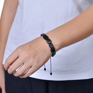 Adjustable braided bracelet with square malachite and black obsidian beads on wrist