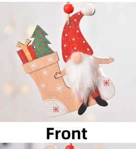 Front view of wooden Christmas gnome ornament with red polka dot hat and gift sock