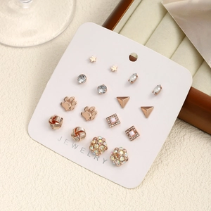 Detailed set of 9 pairs rose gold earrings featuring pearls and crystals on card