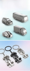 Detailed macro view of various metal car keychains including an F1 racing car model