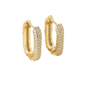 Elegant U-shaped gold earrings with paved clear zircons shown from a 45-degree angle