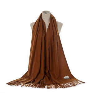 Detail view of the caramel winter warm tassel scarf, soft cashmere feel and fringe.