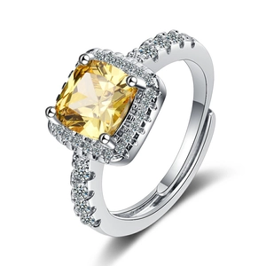 Silver ring with square yellow gemstone and pavé diamonds, adjustable open band style