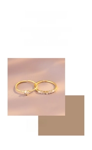 Detail of gold double-layer heart ring with spiral texture and pavé zircon accents