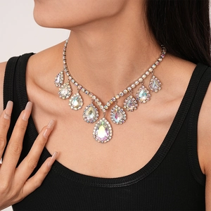 Luxury V-shaped statement necklace with iridescent teardrop crystals on a model