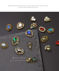 Close-up of mixed flatback glass nail art rhinestones with retro gold metal settings