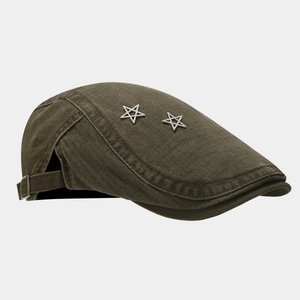 Macro view showing the crystal star studs on a stylish olive green retro flat cap