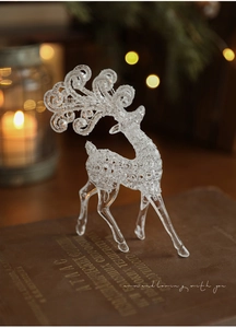 Detailed view of a transparent acrylic reindeer ornament with fine crystalline ice texture