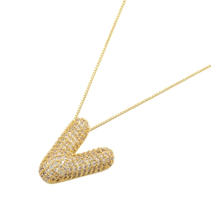Macro detail of 18K gold plated balloon letter V pendant with sparkling cubic zirconia