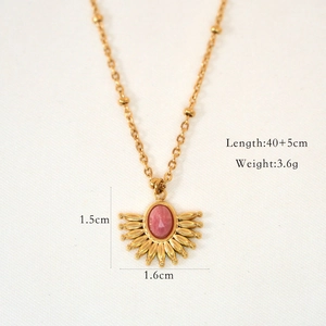 Detail of bohemian fan-shaped gold pendant with pink stone and 40+5cm bead chain