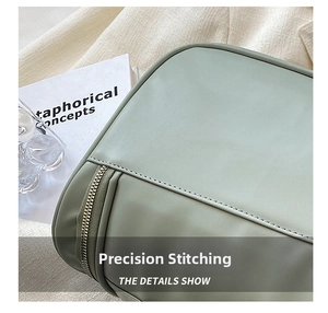 Portable cosmetic bag detail showing fine computer stitching and smooth zipper design.