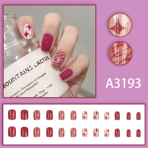 Wildberry red press-on nails set with glitter star patterns and tiger stripe designs