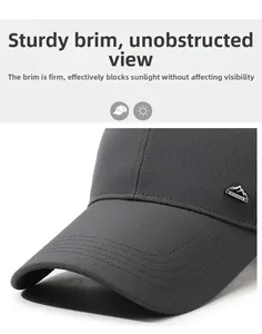 Close-up of dark grey baseball cap featuring breathable fabric and metal mountain logo