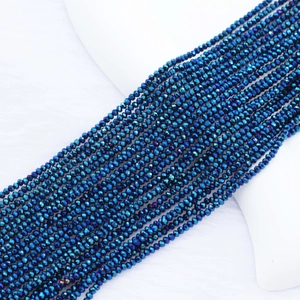 Macro detail of 2mm faceted crystal beads with deep blue electroplated metallic finish