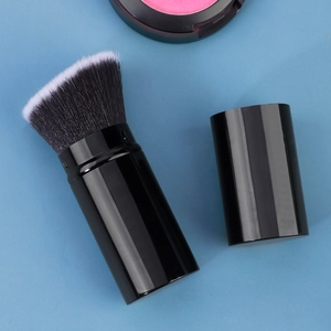 Detail view of the dense synthetic bristles on a retractable black makeup brush