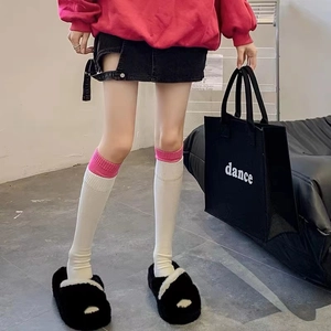 Pink and white knit over-knee socks in a trendy patchwork design for women