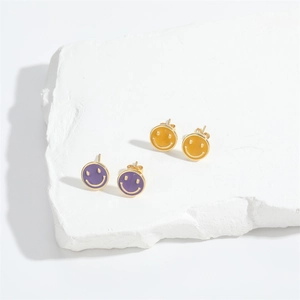 Golden smiley face stud earrings with vibrant purple and yellow enamel inlays