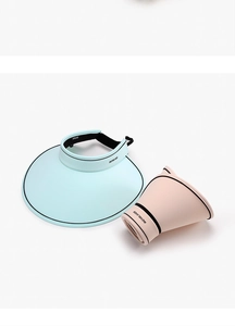 Close-up of portable foldable sun visor hats showing compact roll-up design and wide brim