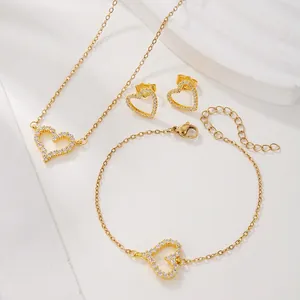 Detail shot of a heart-shaped jewelry set with necklace and bracelet in golden finish