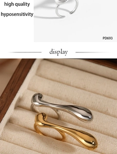 Macro detail of gold and silver irregular fluid metal rings with hypoallergenic property