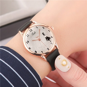 Close-up of a women's quartz watch with a cat motif and elegant black leather strap