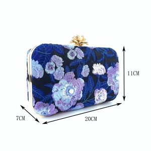 Detailed view of navy embroidery evening clutch with floral beads and dimensions labeled