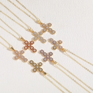 Detailed view of cross pendants with multi-color cubic zirconia in 14K gold plating