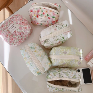 Flat lay of colorful quilted floral cotton makeup bags with elegant zipper closures