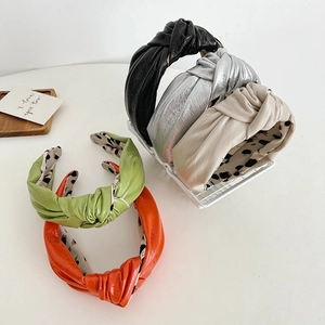 Set of 5 knotted PU leather headbands in assorted colors with leopard print lining