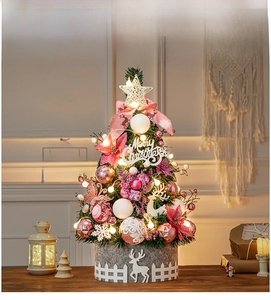 Close-up of pink 60cm tabletop Christmas tree with warm LED lights and felt reindeer base