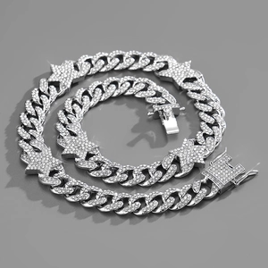 Close-up of silver Cuban link chain with iced-out star charms and pave rhinestones