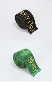 Close-up of Merry Christmas velvet ribbon with gold stars and lettering for gift wrapping