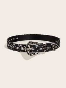 Macro detail of black denim belt with silver western buckle and metallic studs