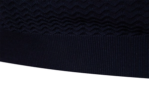 Detailed shot of navy blue knit fabric with wave texture and ribbed hem on short sleeve